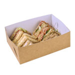 Extra small kraft platter base, with kraft exterior and white interior, filled with twelve sandwich rounds, neatly arranged in two rows.